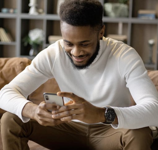 Photo of a man texting on his phone