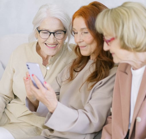 Photo of elderly women making a video call on the phone together